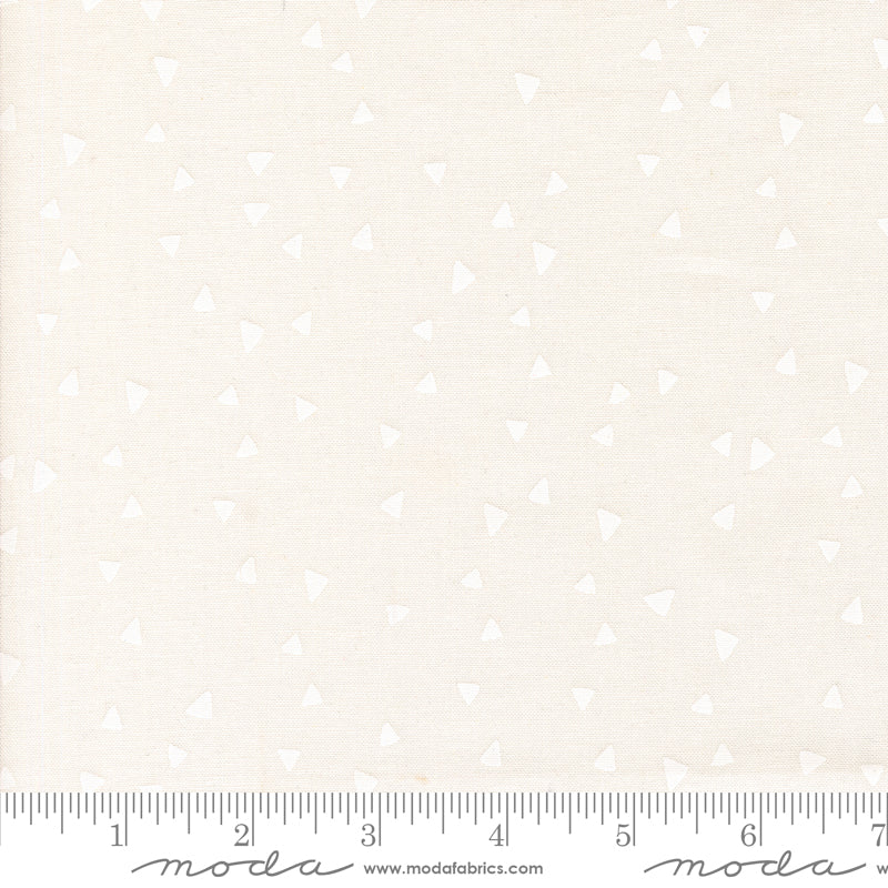 White fabric with a subtle pattern and a ruler at the bottom for scale.