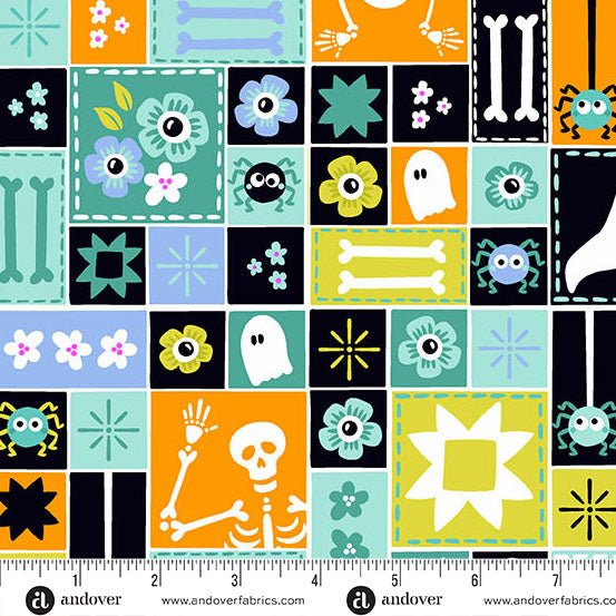 Halloween-themed fabric pattern with squares featuring ghosts, bones, and flowers, measured by a ruler.