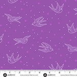 Purple fabric with white bird and star pattern, ruler at the bottom for scale.