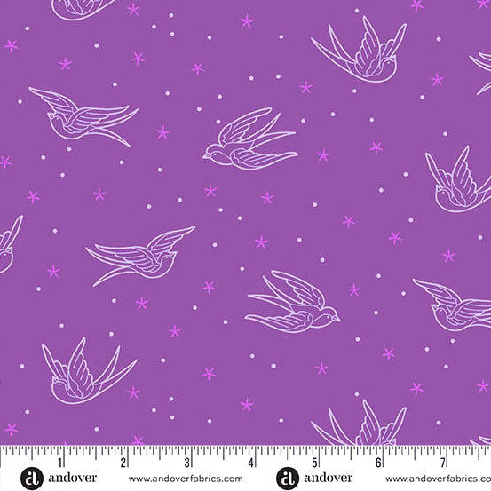 Purple fabric with white bird and star pattern, ruler at the bottom for scale.
