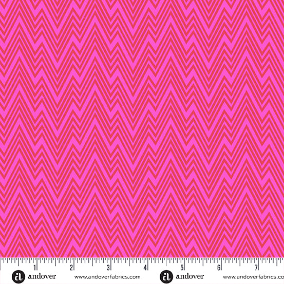 Pink fabric with zigzag pattern and a ruler at the bottom for scale.