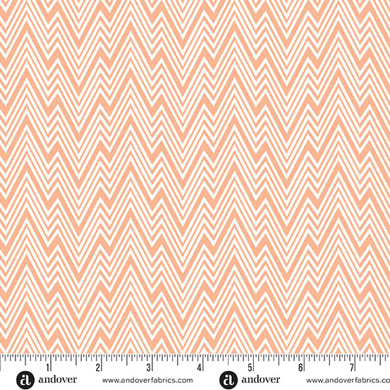 Fabric with a zigzag pattern and a ruler at the bottom for scale, on a peach background.