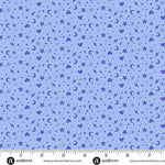 Blue fabric with star, heart, and moon pattern and a ruler at the bottom for scale.