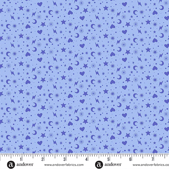 Blue fabric with star, heart, and moon pattern and a ruler at the bottom for scale.