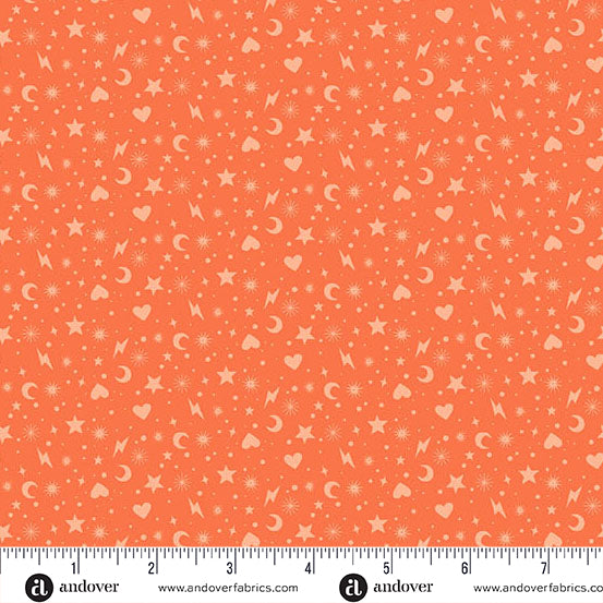 Coral fabric with star, moon, and heart pattern and a ruler for scale.
