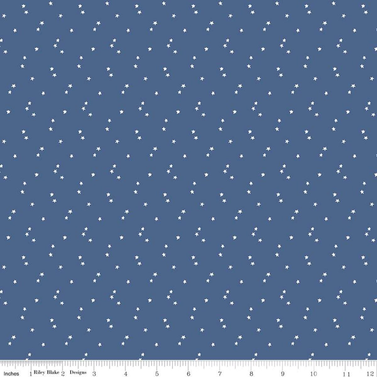 Blue fabric with white star pattern and a ruler at the bottom for scale.