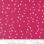 Fabric with white triangle pattern on a pink background, featuring Moda label.