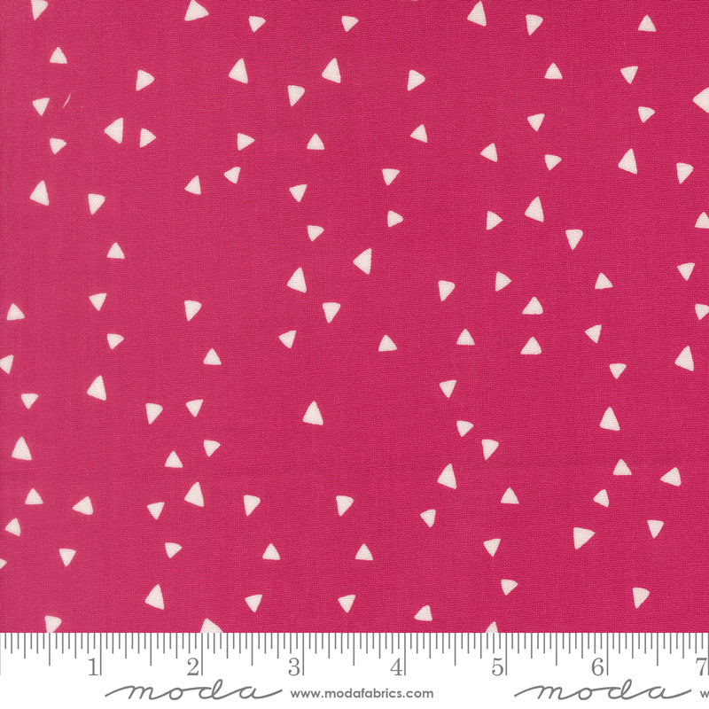 Fabric with white triangle pattern on a pink background, featuring Moda label.