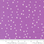 Purple fabric with white triangle pattern and Moda label
