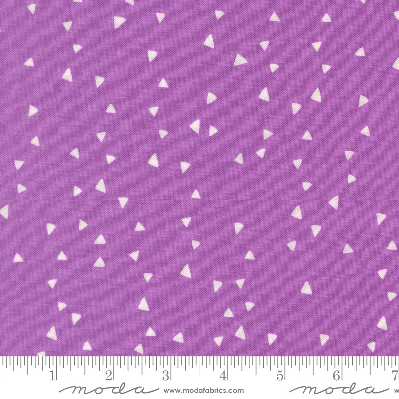 Purple fabric with white triangle pattern and Moda label