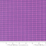 Purple fabric with a grid pattern and Moda label at the bottom.