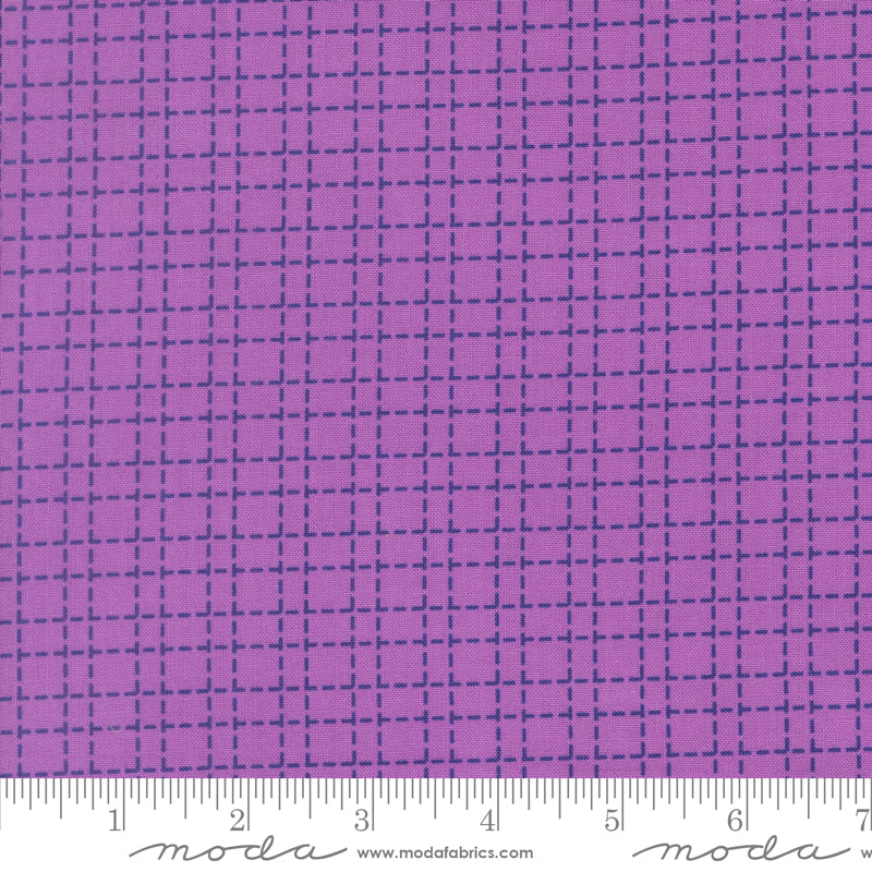 Purple fabric with a grid pattern and Moda label at the bottom.