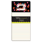 A vertical notepad with a black top section decorated with colorful flowers and a sewing machine illustration, plus a black middle band with the text 'Sarah Watts for CraftedMoon' and 'therapeutic'. The lower portion is white lined paper.
