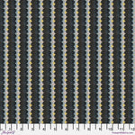 Patterned fabric with black, gray, and yellow design on a ruler for scale