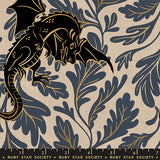 Fabric with dragon and leaf pattern in black and gold on a beige background, featuring Ruby Star Society label.