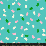 Pattern of colorful gummy bears on a teal background with a ruler at the bottom.