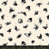 Pattern of black spiders on a beige background with a ruler at the bottom.