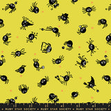 Pattern of black spiders on a yellow background with a ruler at the bottom, featuring the Ruby Star Society logo.