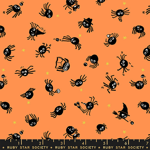 Pattern of black spiders on an orange background with a ruler at the bottom.