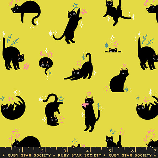Pattern of black cats on a yellow background with colorful accents, featuring a ruler at the bottom.
