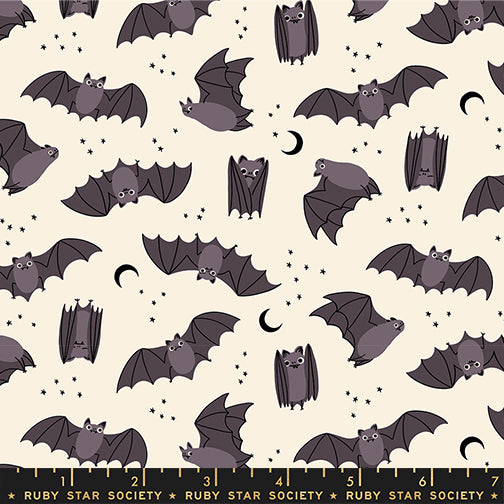 Pattern of cartoon bats on a beige background with a ruler at the bottom.