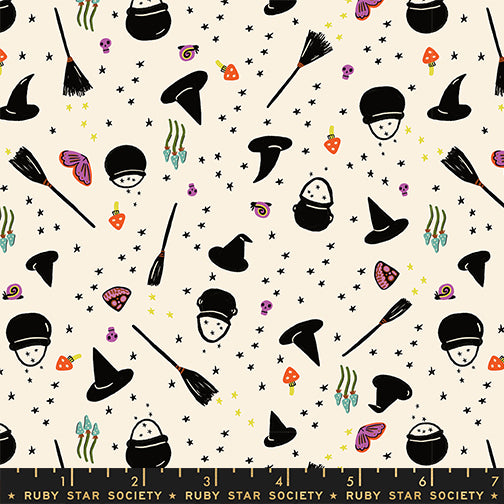 Halloween-themed fabric pattern with witch hats, brooms, and candy on a beige background.