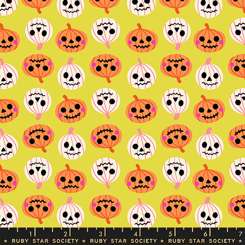 Pattern of pumpkins and ghosts on a yellow background with a ruler at the bottom.