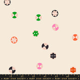 Patterned fabric with colorful geometric shapes on a beige background, featuring the Ruby Star Society label.