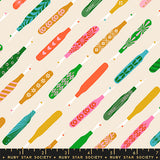 Pattern of colorful oars on a beige background with Ruby Star Society label.