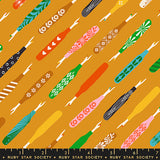 Pattern of colorful fabric swatches with various designs on a mustard yellow background, featuring the Ruby Star Society label.