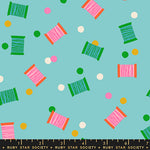 Colorful thread spools and bobbins pattern on a blue background with a Ruby Star Society label at the bottom.