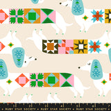 Patterned fabric with dogs and geometric shapes on a beige background, featuring Ruby Star Society branding.