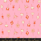 Patterned fabric with small illustrations on a pink background, featuring a ruler at the bottom.