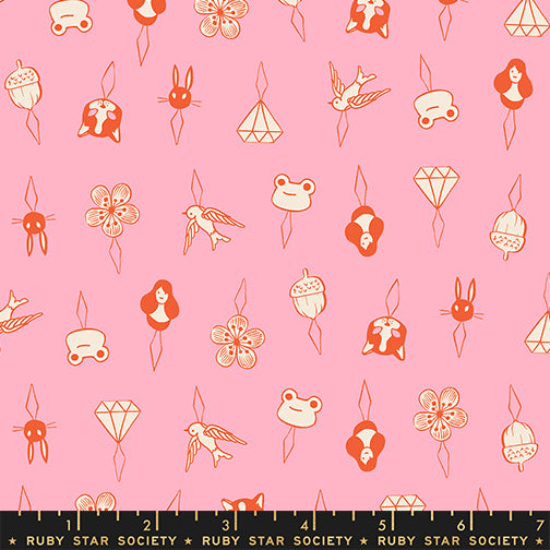 Patterned fabric with small illustrations on a pink background, featuring a ruler at the bottom.