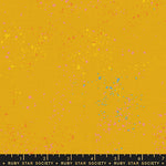 specs scattered on yellow canvas