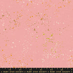 specs scattered on pink canvas