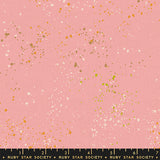 specs scattered on pink canvas