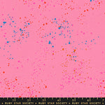 specs scattered on pink canvas