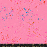 specs scattered on pink canvas