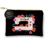 A black zippered pouch featuring a retro-style illustration of a cream sewing machine surrounded by pink and orange flowers, with the text 'my therapist' and a hanging circular tag reading 'Sarah + WIP x CRAFTEDMOON'.